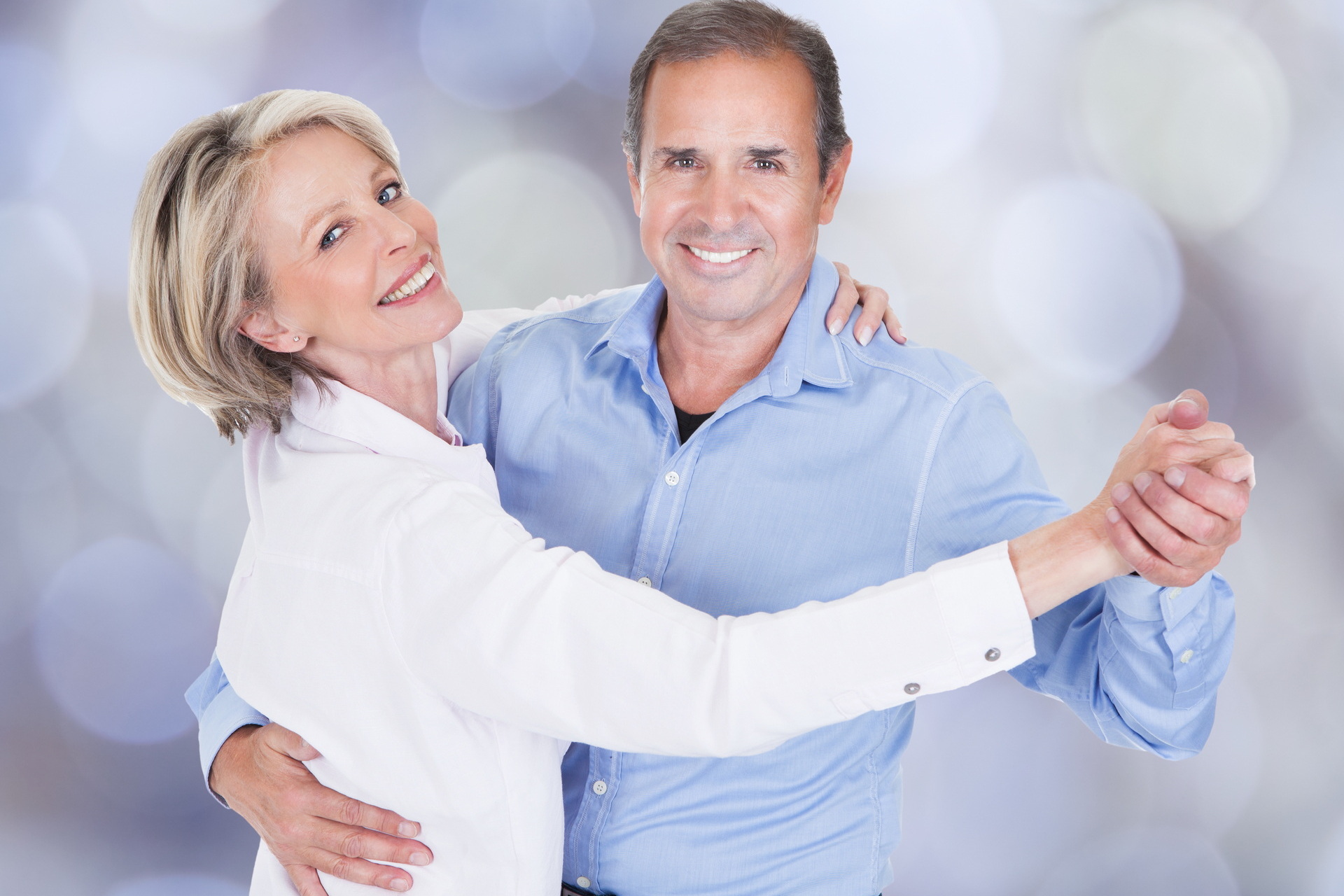 Happy Mature Couple Dancing Isolated Over White Background